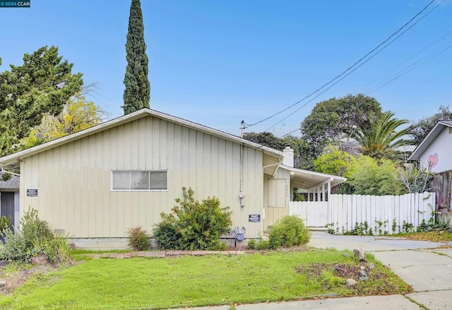 view of side of property with a yard