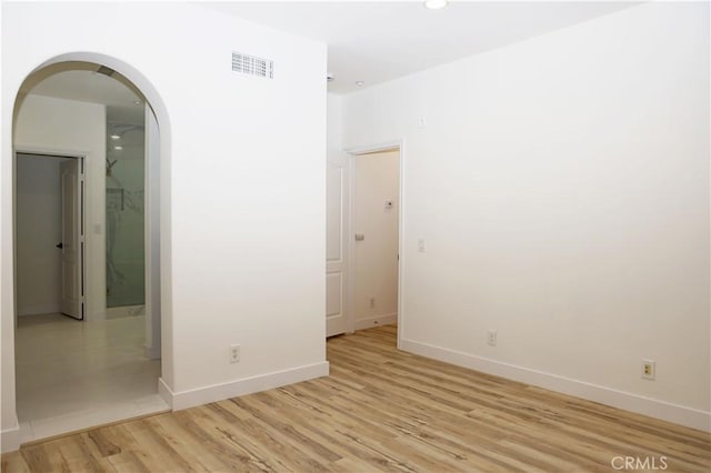 spare room with light hardwood / wood-style floors