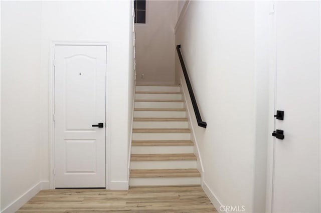 stairs with hardwood / wood-style floors