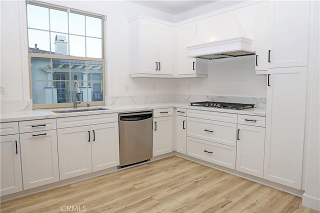 kitchen featuring stainless steel appliances, sink, white cabinetry, light hardwood / wood-style floors, and custom exhaust hood