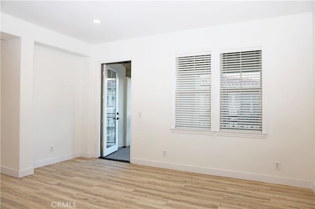 unfurnished room with light wood-type flooring