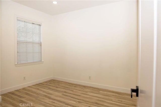 spare room with wood-type flooring