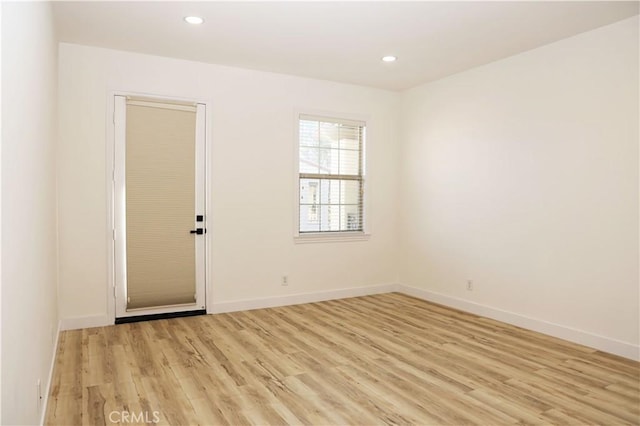 spare room with light hardwood / wood-style flooring