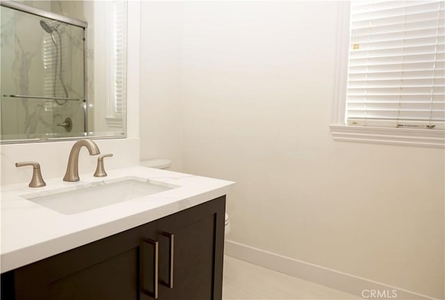 bathroom with vanity and a shower with shower door