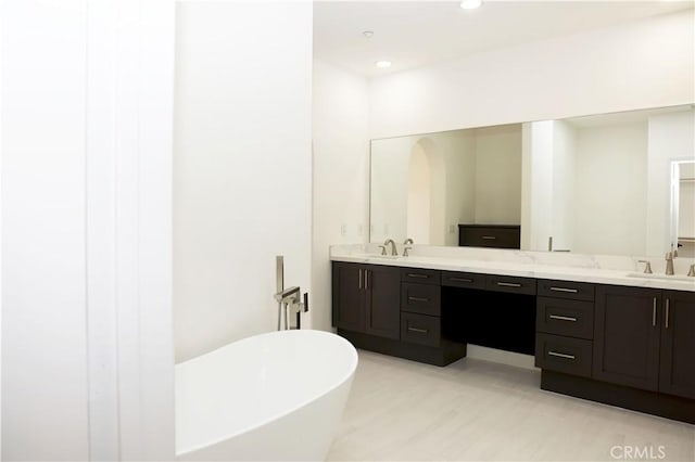 bathroom featuring vanity and a tub