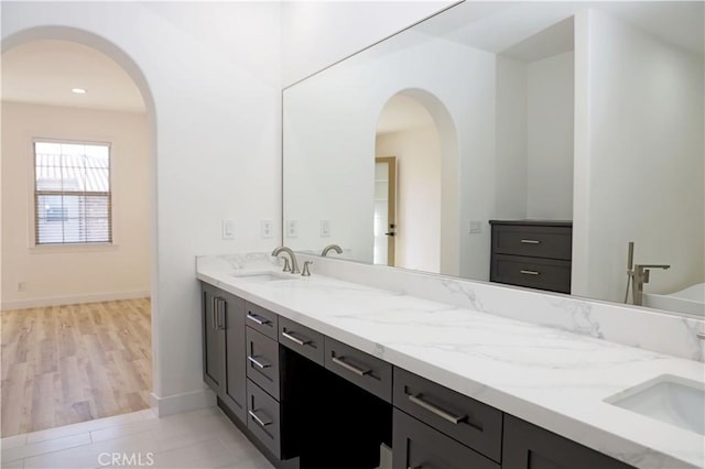 bathroom featuring vanity, tile patterned floors, and a tub