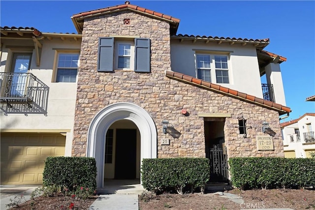 mediterranean / spanish-style house with a garage