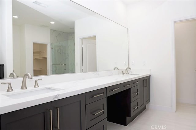 bathroom featuring an enclosed shower and vanity