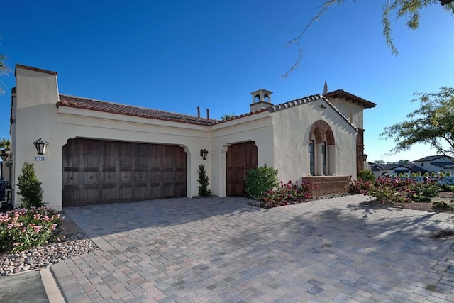 mediterranean / spanish home with a garage