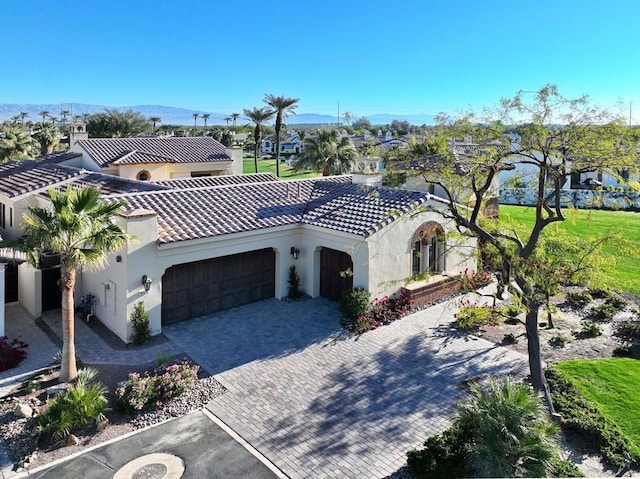 view of front of home featuring a garage and a mountain view