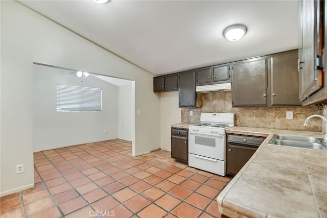 kitchen with backsplash, vaulted ceiling, sink, white range with gas stovetop, and light tile patterned floors