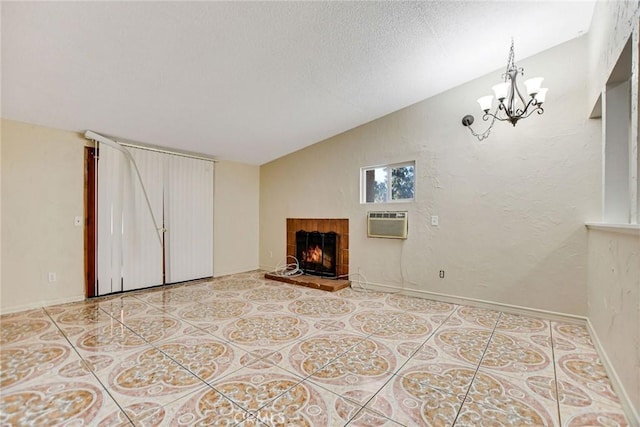 unfurnished living room featuring light tile patterned floors, a wall mounted AC, lofted ceiling, a chandelier, and a tile fireplace