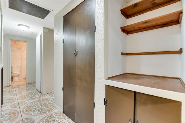 hallway featuring light tile patterned floors