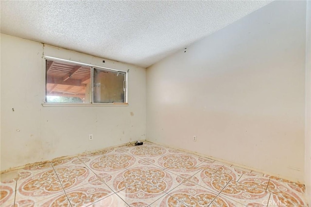 spare room featuring a textured ceiling