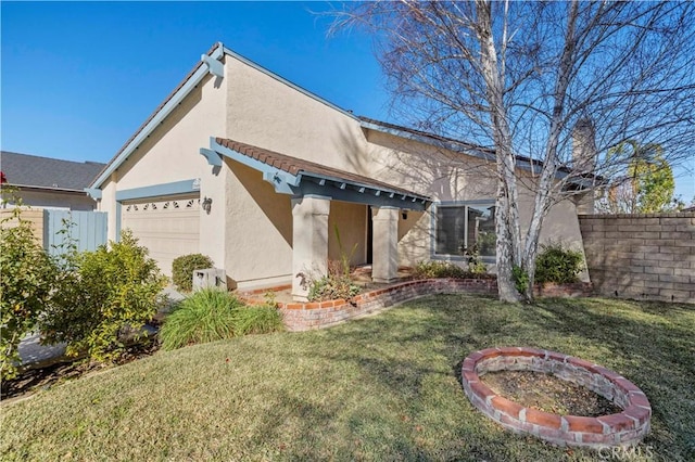 back of property featuring a garage and a yard