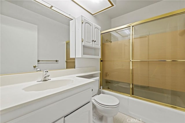 full bathroom with toilet, bath / shower combo with glass door, and vanity