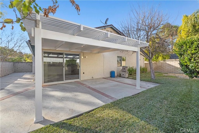 back of house with a patio area, a lawn, and a pergola