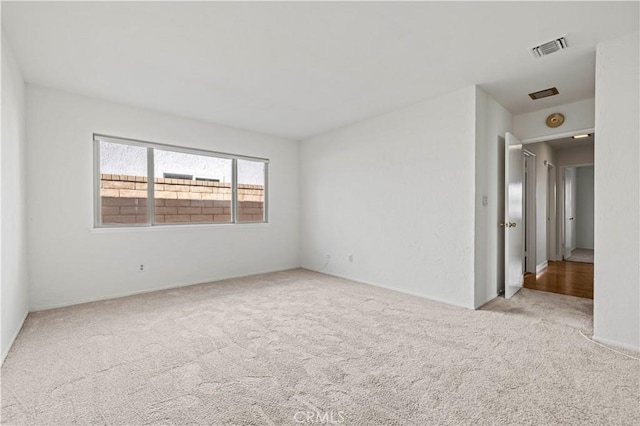 unfurnished room featuring light colored carpet