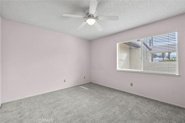 spare room featuring a textured ceiling, ceiling fan, and carpet floors