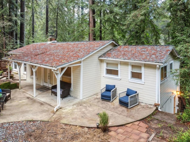 back of house featuring outdoor lounge area and a patio