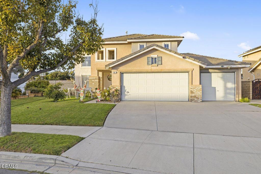 view of front of house with a front yard and a garage