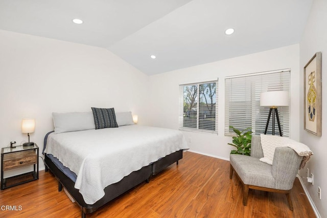 bedroom featuring hardwood / wood-style floors and lofted ceiling