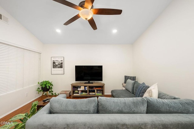 living room featuring vaulted ceiling, ceiling fan, and wood-type flooring