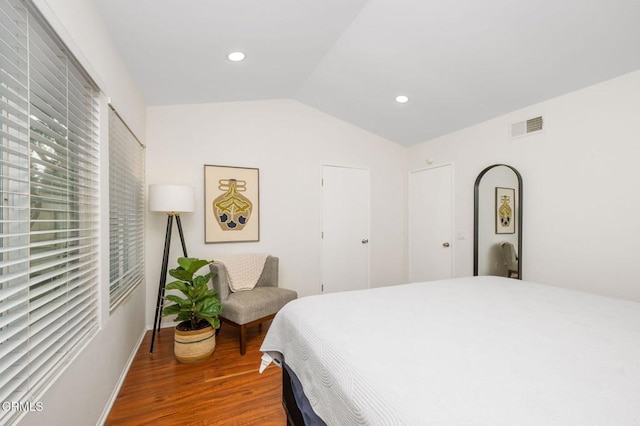 bedroom featuring wood-type flooring and lofted ceiling