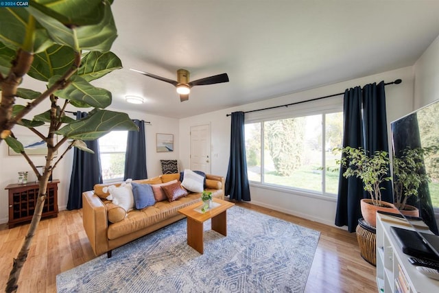 living room featuring ceiling fan, a healthy amount of sunlight, and light hardwood / wood-style flooring