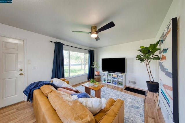 living room featuring ceiling fan and light hardwood / wood-style flooring