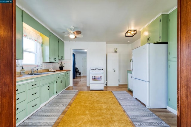 kitchen with ceiling fan, decorative backsplash, sink, white appliances, and dark hardwood / wood-style flooring