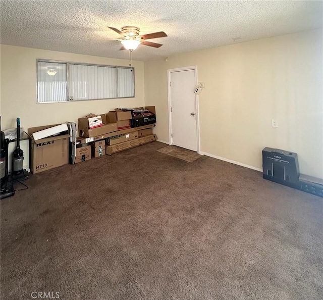 carpeted living room featuring ceiling fan and a textured ceiling