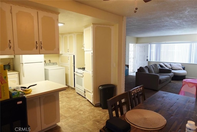 kitchen featuring washer / dryer, a textured ceiling, white refrigerator, ceiling fan, and oven