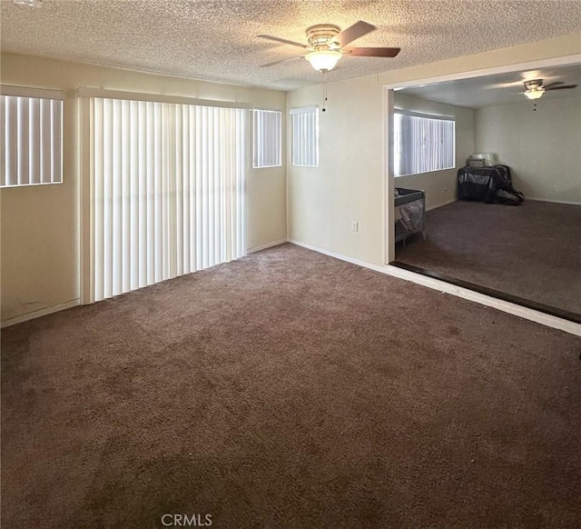 spare room with ceiling fan, carpet floors, and a textured ceiling