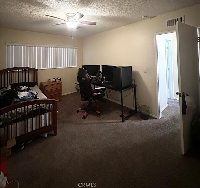 carpeted bedroom with ceiling fan and a textured ceiling