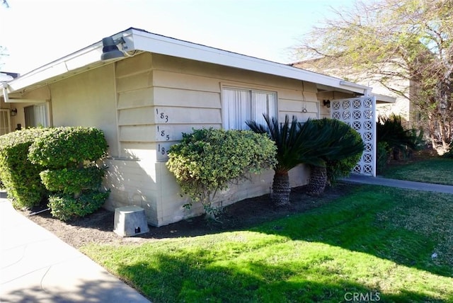 view of side of home featuring a yard