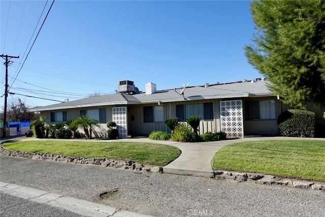 ranch-style house with a front lawn