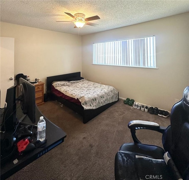 carpeted bedroom with ceiling fan and a textured ceiling