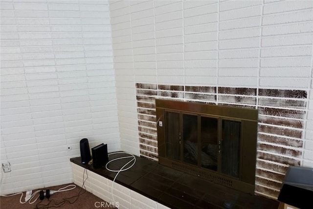 interior details with a brick fireplace