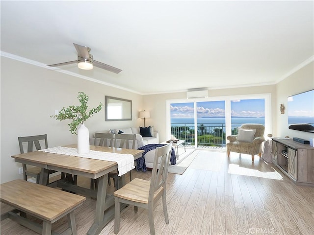 dining space with ceiling fan, ornamental molding, a wall unit AC, and light hardwood / wood-style flooring