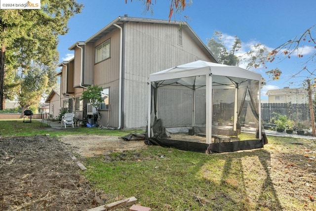 view of side of property featuring a gazebo and a yard