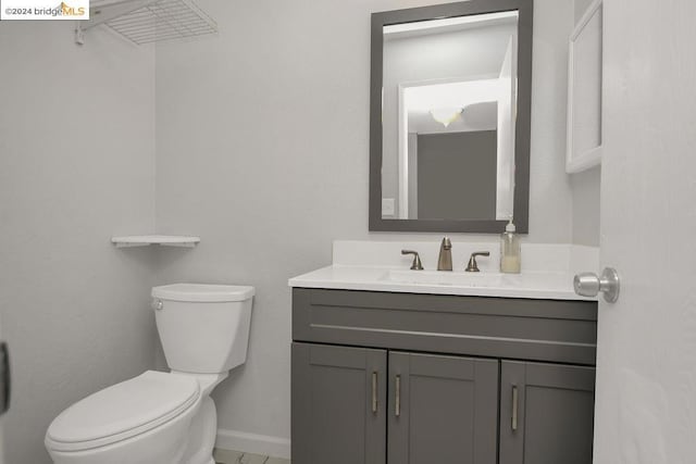 bathroom with toilet and vanity