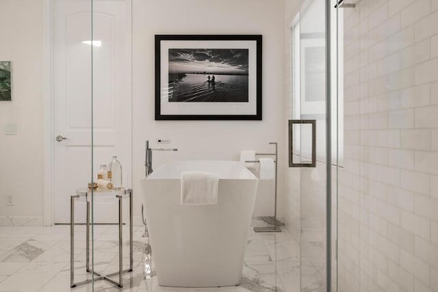 bathroom featuring shower with separate bathtub