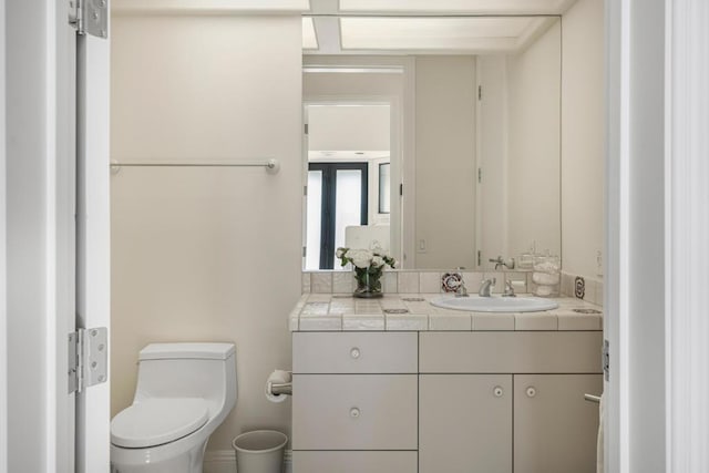 bathroom featuring toilet and vanity