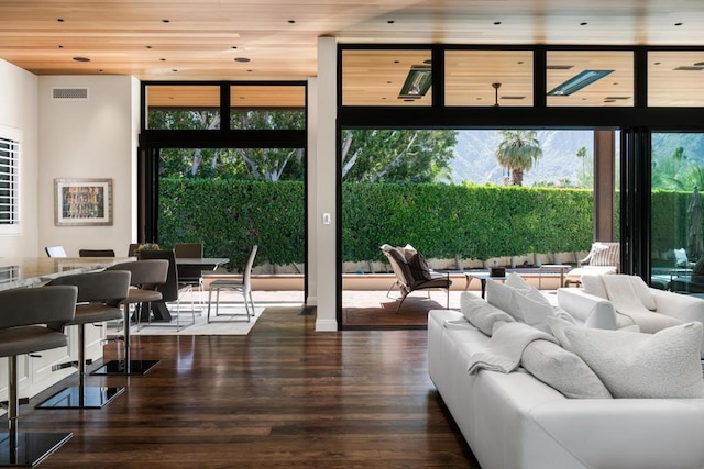 interior space featuring dark wood-type flooring, plenty of natural light, and wood ceiling