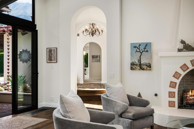 living room with dark hardwood / wood-style floors and a notable chandelier