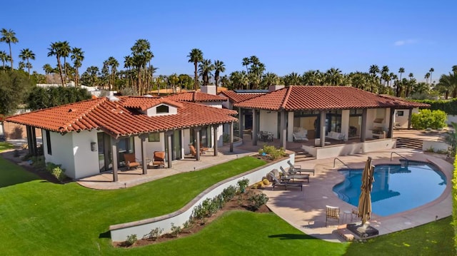 rear view of property with a lawn and a patio area