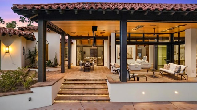 patio terrace at dusk with an outdoor hangout area