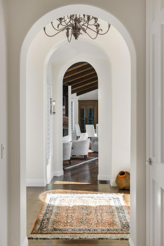 corridor featuring vaulted ceiling with beams