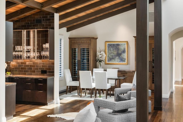 dining space featuring beam ceiling, high vaulted ceiling, wood ceiling, and light hardwood / wood-style floors